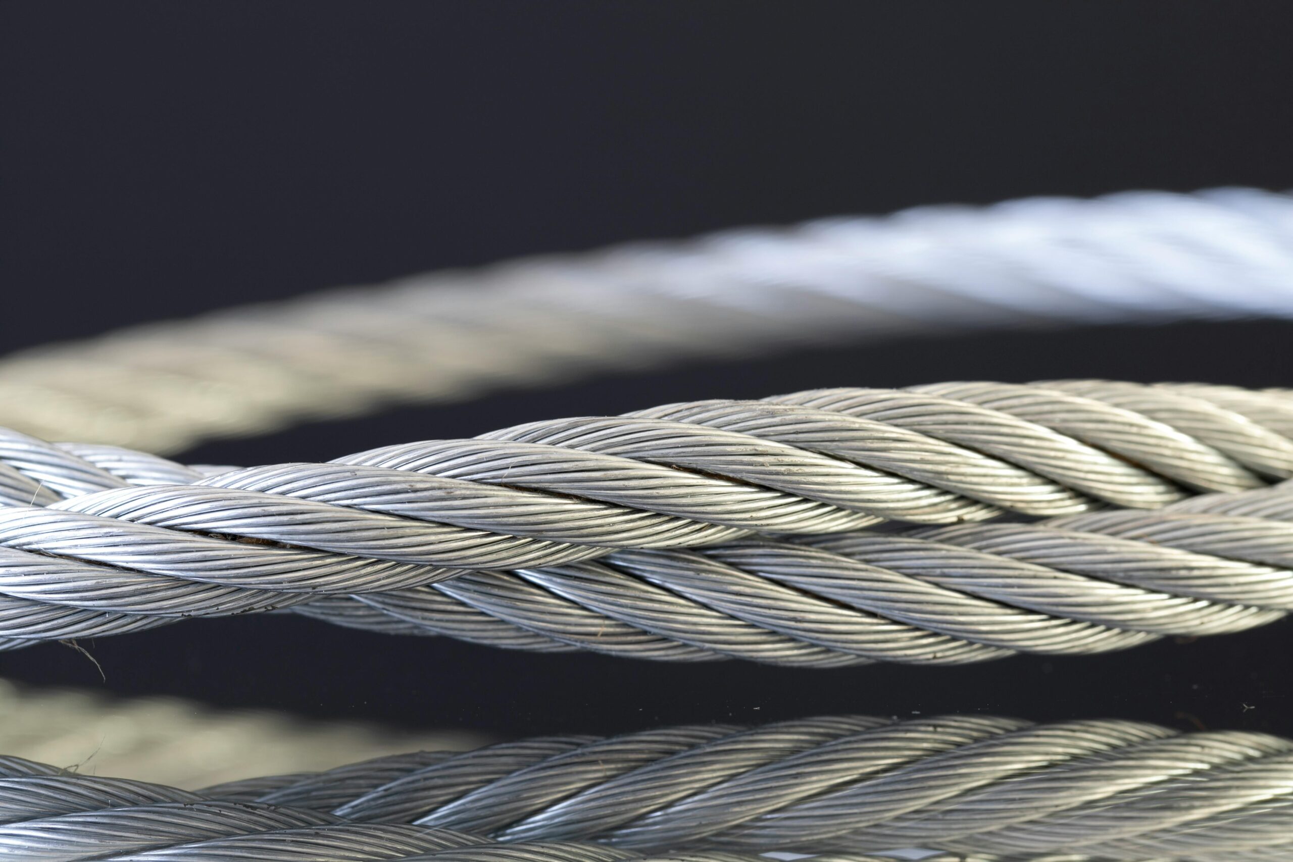 Detailed shot of twisted steel cables showcasing industrial strength and design.